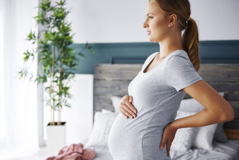 Young pregnant woman suffering from backache